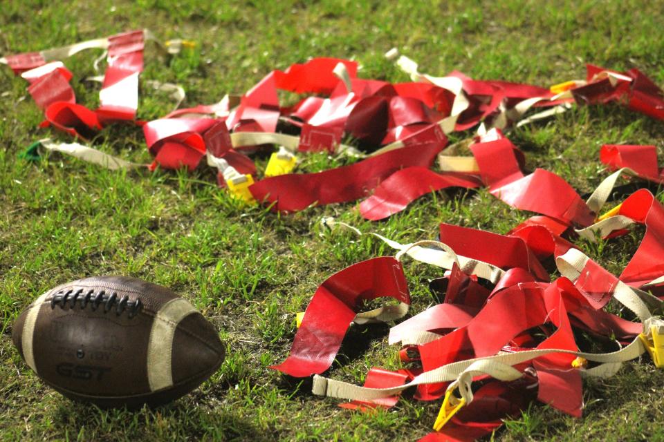 STOCK | Flag belts and a football rest on the field after an FHSAA Region 2-1A high school girls flag football first-round playoff between Menendez and Stanton College Prep in Jacksonville, Florida, on April 17, 2024. [Clayton Freeman/Florida Times-Union]