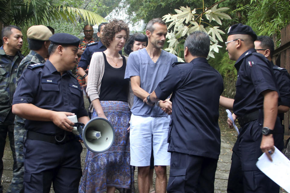 Sebastien and Meabh Quoirin with police officers in Malaysia.