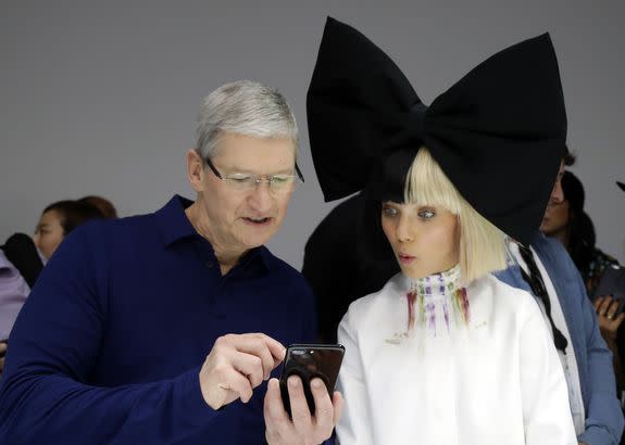 At least Apple CEO Tim Cook (left) surprised Sia's surrogate and favorite dancer Maddie Ziegler.