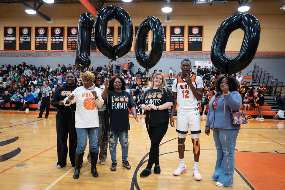 Friends and family celebrate with North High's Joe Okla after he scored his 1,000th point against St. John's.