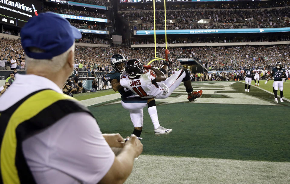 Atlanta Falcons' Julio Jones (11) pulls in a pass out bounds after a hit by Philadelphia Eagles' Ronald Darby (21) during the final second of an NFL football game early Friday, Sept. 7, 2018, in Philadelphia. Philadelphia won 18-12. (AP Photo/Michael Perez)