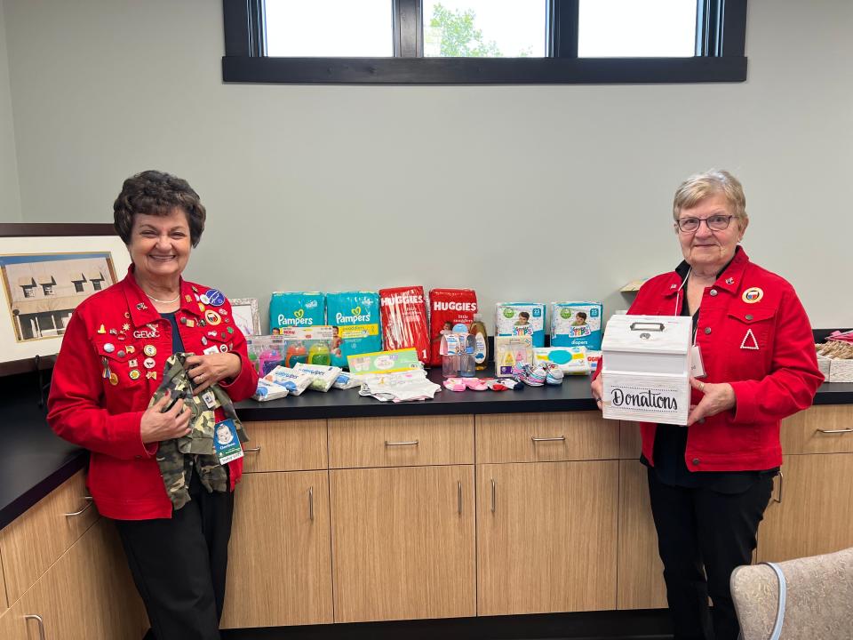 Harriet Spiegel, left, and Clara Ruttkofsky, right, members of Adrian's chapter of the General Federation of Women's Clubs display some of the items donated earlier this year by the club to the Care Pregnancy Center of Lenawee.