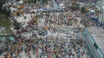 This aerial view shows firefighters, policemen, soldiers and volunteers searching for survivors in a flattened building in Mexico City