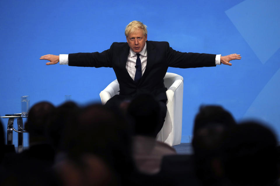 Conservative party leadership candidate Boris Johnson gestures while taking questions during a Conservative leadership hustings at ExCel Centre in London, Wednesday, July 17, 2019. The two contenders, Jeremy Hunt and Boris Johnson are competing for votes from party members, with the winner replacing Prime Minister Theresa May as party leader and Prime Minister of Britain's ruling Conservative Party. (AP Photo/Frank Augstein)