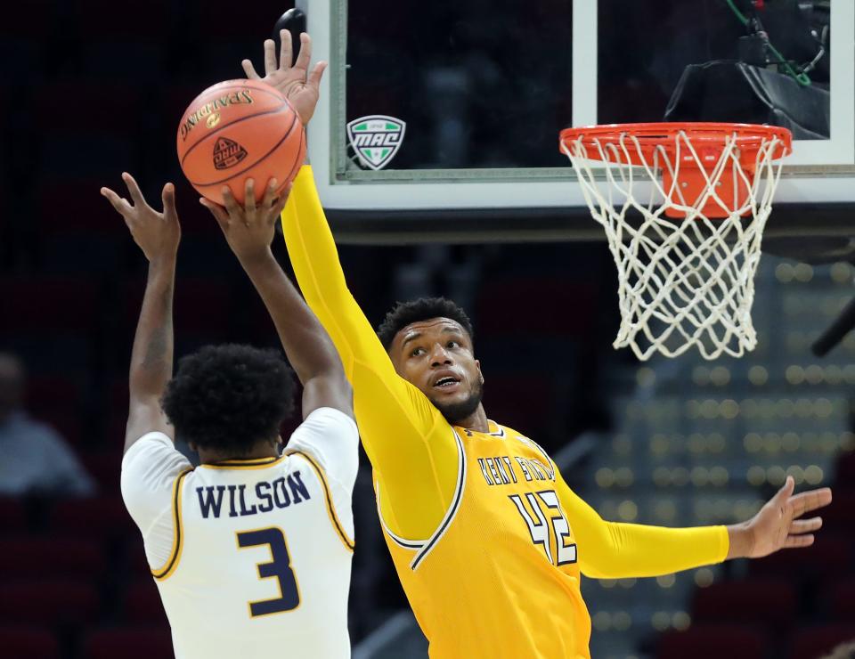 Kent State center Cli'Ron Hornbeak looks to block a first-half shot by Toledo guard Sonny Wilson in the Mid-American Conference Tournament quarterfinals, Thursday, March 14, 2024, in Cleveland.