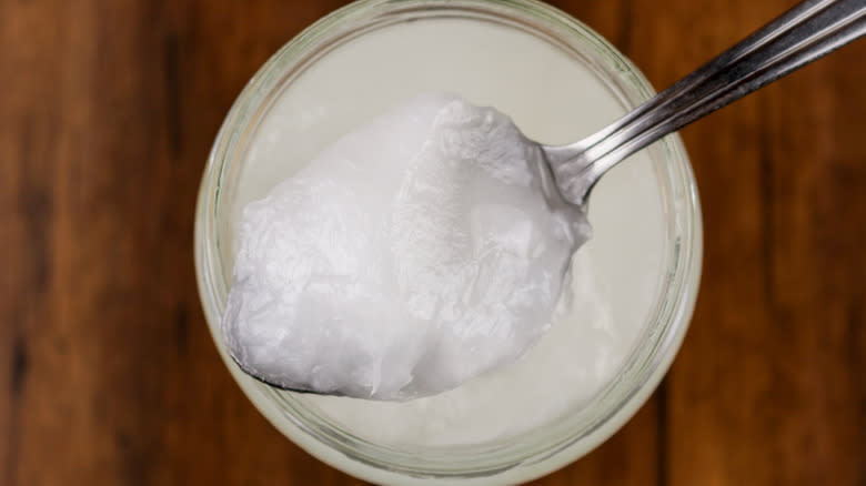 coconut oil on spoon out of jar