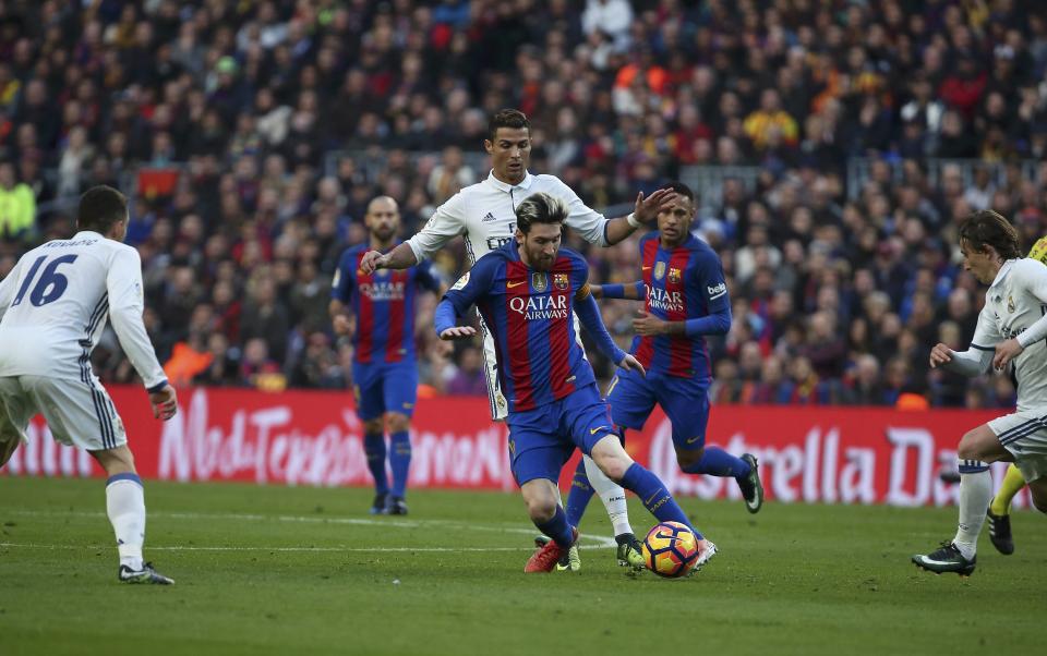 Football Soccer - Barcelona v Real Madrid - Spanish La Liga Santander- Nou Camp Stadium, Barcelona, Spain - 3/12/16. Real Madrid's Cristiano Ronaldo and Barcelona's Lionel Messi in action during the "Clasico". REUTERS/Sergio Perez