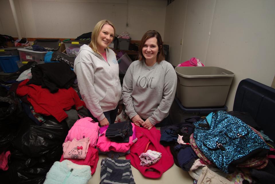 Wandering Heart founders Samantha Nurmenniemi of Bridgewater and Amanda Durante of Franklin stand with their collection of donated clothes at their wharehouse on Liberty Street in Rockland on Wed. Jan. 19, 2022.