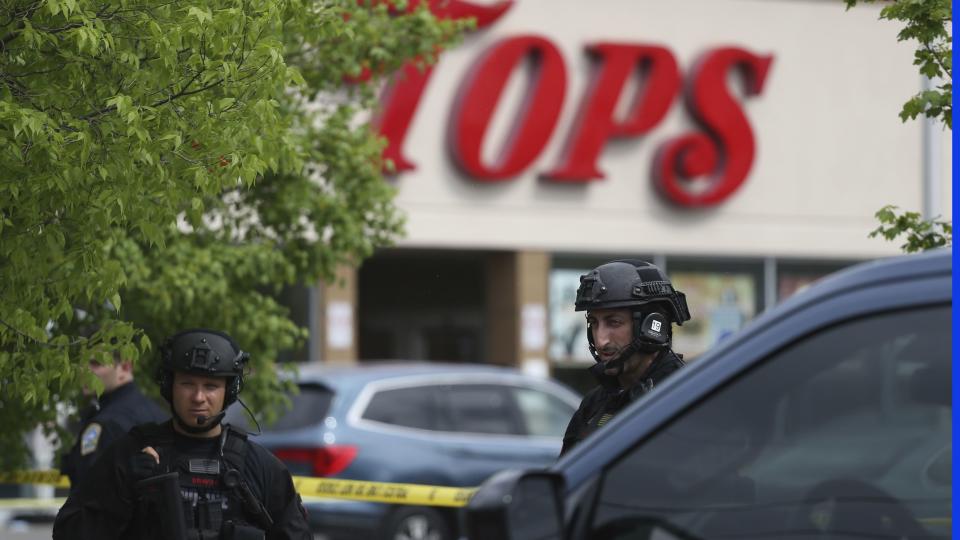 Police secure a perimeter after a shooting at a supermarket, Saturday, May 14, 2022, in Buffalo, N.Y.