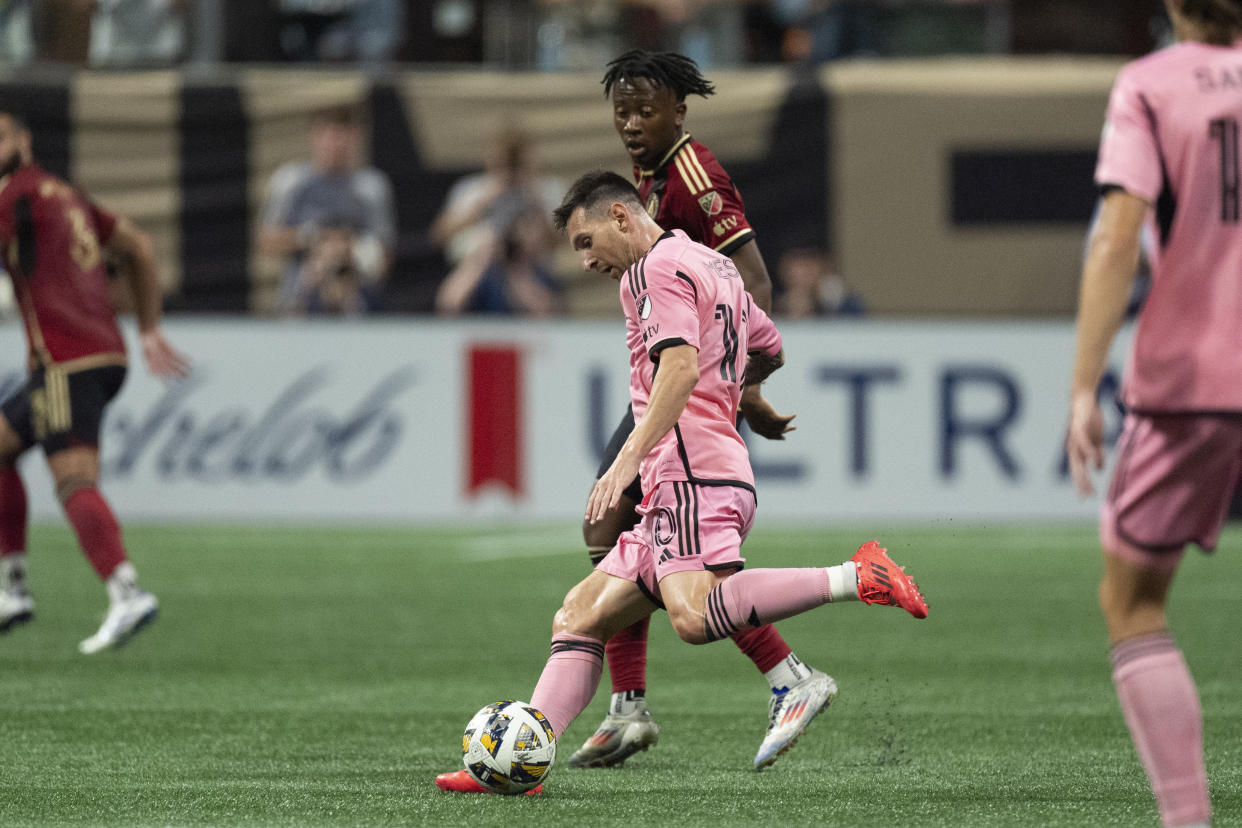 Inter Miami forward Lionel Messi (10) works in front of Atlanta United midfielder Ajani Fortune (35) during the second half of a MLS soccer match Wednesday, Sept. 18, 2024. (AP Photo/John Bazemore)