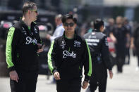 Sauber driver Zhou Guanyu of China, front right, walks on the paddock area ahead of the Chinese Formula One Grand Prix at the Shanghai International Circuit in Shanghai, China, Thursday, April 18, 2024. (AP Photo/Andy Wong)