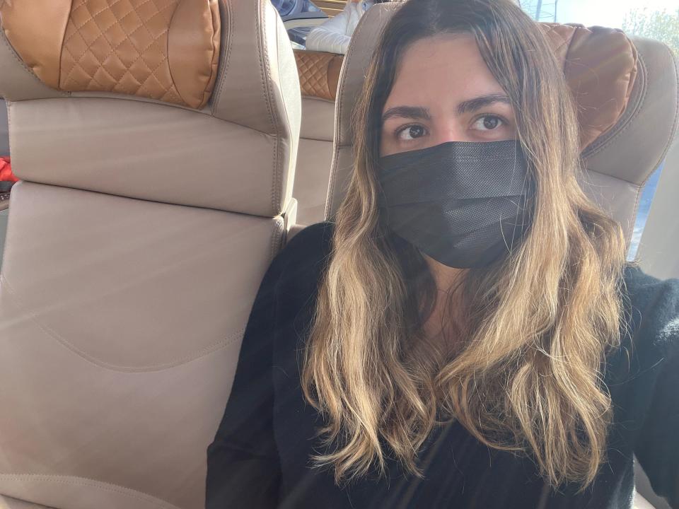 Selfie of the writer wearing a black mask and black shirt and sitting in train