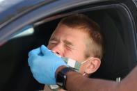 Hugo Boserup, 22, is given a PCR coronavirus test, as the global outbreak of the coronavirus disease (COVID-19) continues, in Malibu