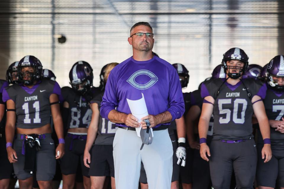 Canyon's coach Todd Winfrey stands in front of his athletes before the game against Canyon, Thursday, Sept. 15, 2022, at Happy State Bank Stadium in Canyon. Canyon won, 35-32.