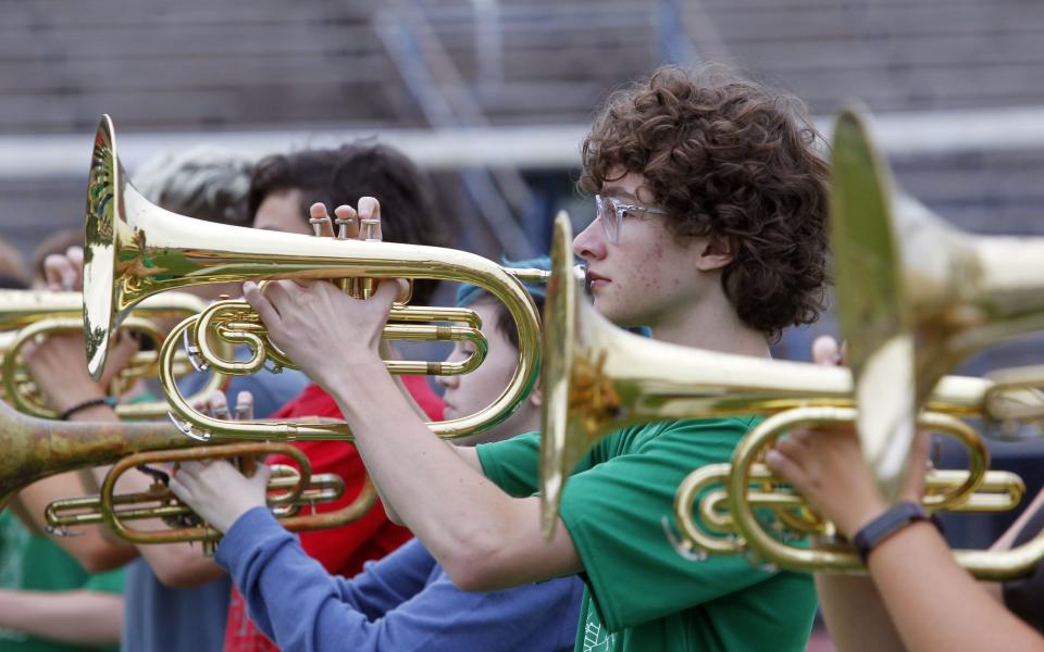 Gahanna senior and mellophone squad leader Josh Grieco goes through drills during band practice July 26.