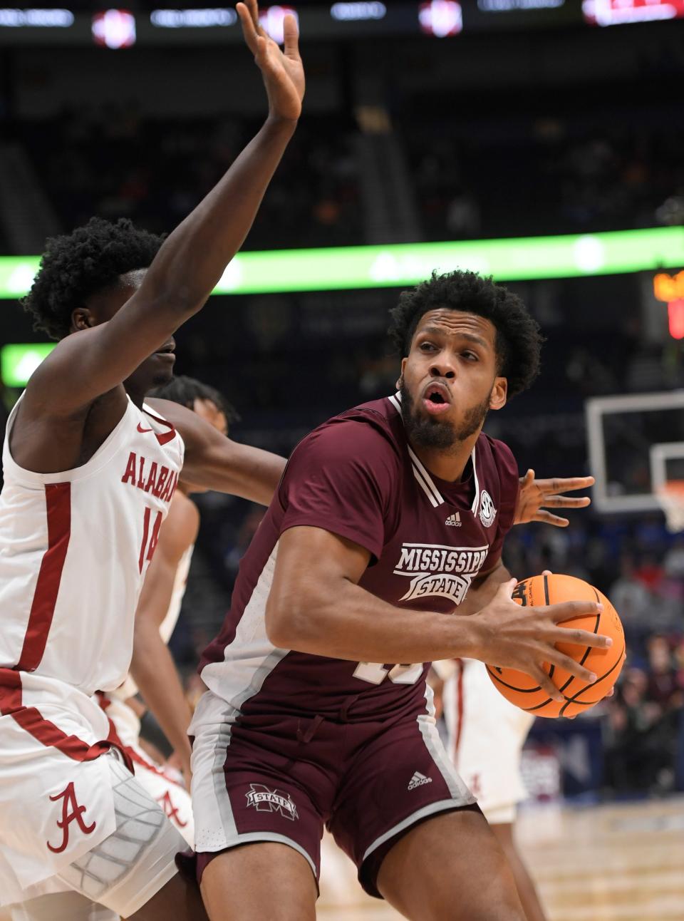 Mississippi State forward Will McNair Jr. (13) posts up against Alabama's Charles Bediako (14) during an SEC Tournament quarterfinal game on March 10 in Nashville. McNair announced his commitment to Kansas State on Friday.