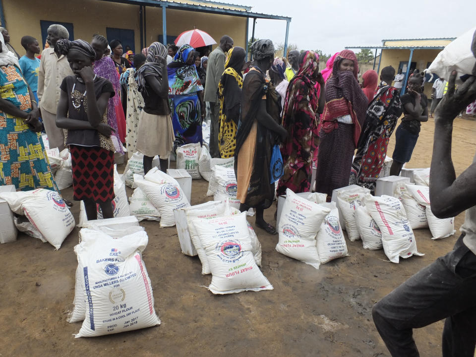 FILE - In this Wednesday, April 19, 2017 file photo, South Sudanese wait to collect food donated by Saudi Arabia's government through the Islamic Council of South Sudan, in Juba, South Sudan. Whether pressured to speak up after receiving assistance or making a diplomatic play for more, some African countries are expressing support for Saudi Arabia as shocking details in the killing of Jamal Khashoggi approached a crescendo, with South Sudan issuing a rare statement praising the Saudi position to defuse the crisis as "honorable". (AP Photo/Samir Bol, File)