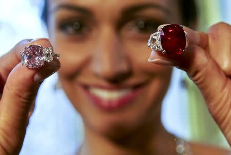 A model holds the "Sunrise Ruby" (top) and the "Historic Pink Diamond" during an auction preview at Sotheby's auction house in Geneva, Switzerland, in this May 6, 2015 file photo. REUTERS/Denis Balibouse/Files