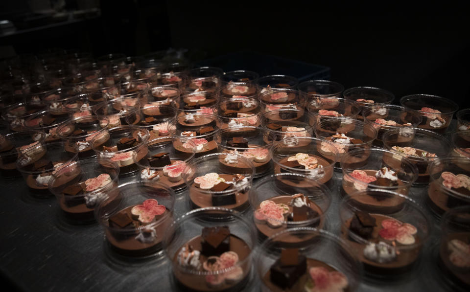 A dessert of chocolate, Amarena cherry, almond, ricotta and lime is ready to be packed into nearly 600 take-away orders at Sergio Herman's Le Pristine restaurant in Antwerp, Belgium, Saturday, Nov. 7, 2020. Of all the many challenges the pandemic throws up for all kinds of professions, this one has been particularly tough: How to put a three-star chef into a takeout box. (AP Photo/Virginia Mayo)
