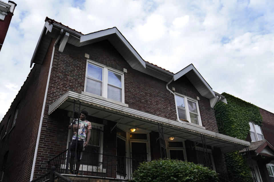 A man stands outside of the home of Craig Elazer in St. Louis on Friday, May 21, 2021. Elazer died from a fentanyl overdose. As the COVID-19 pandemic intensified America’s opioid addiction crisis in nearly every corner of the country, many Black neighborhoods like this one suffered most acutely. (AP Photo/Brynn Anderson)