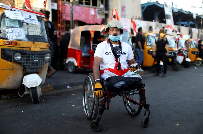 Hamza, an Iraqi demonstrator, poses for a photograph during the ongoing anti-government protests in Baghdad