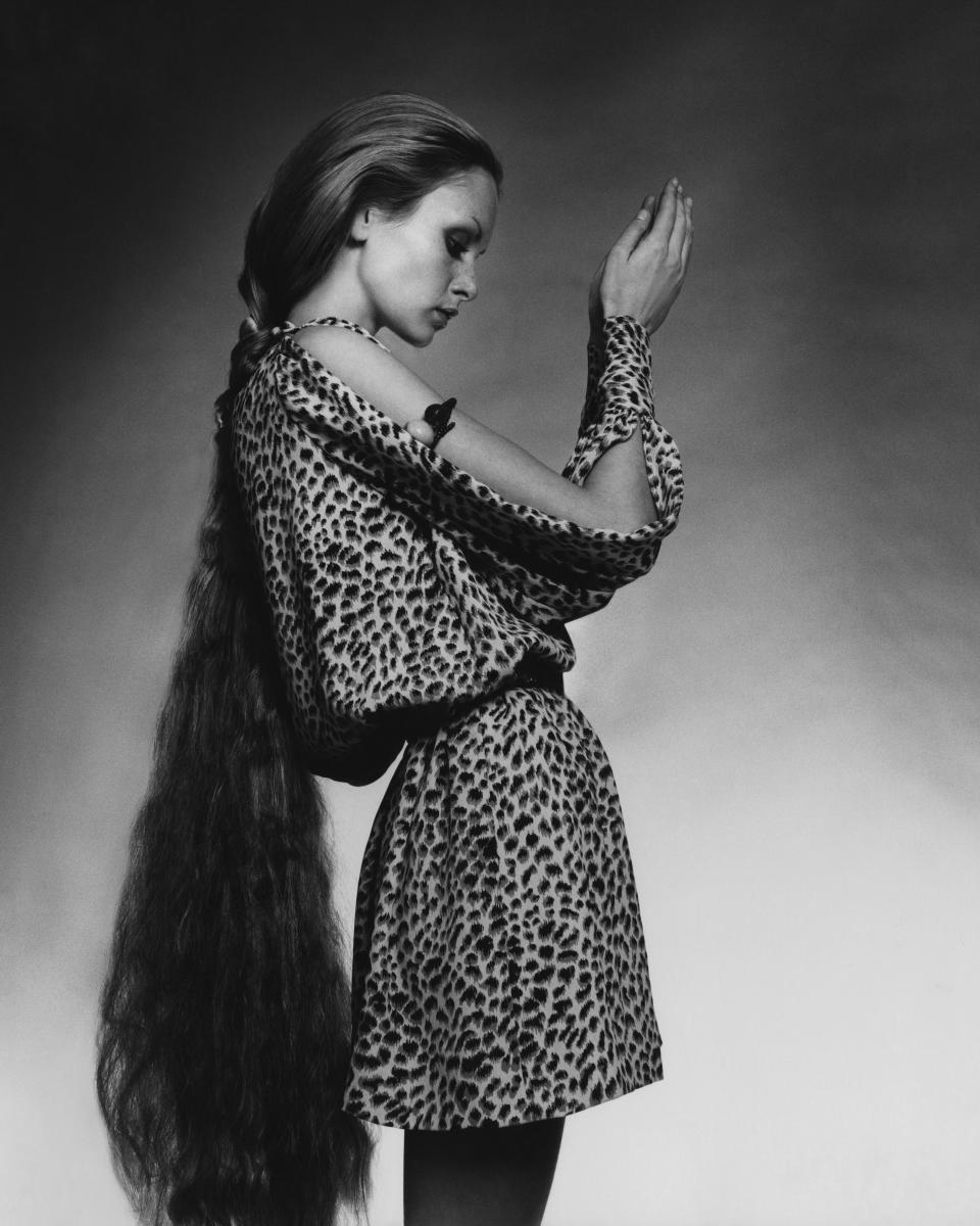 Twiggy wears a short, leopard-print tunic dress with slashed sleeves by Bill Tice for Royal Robes.