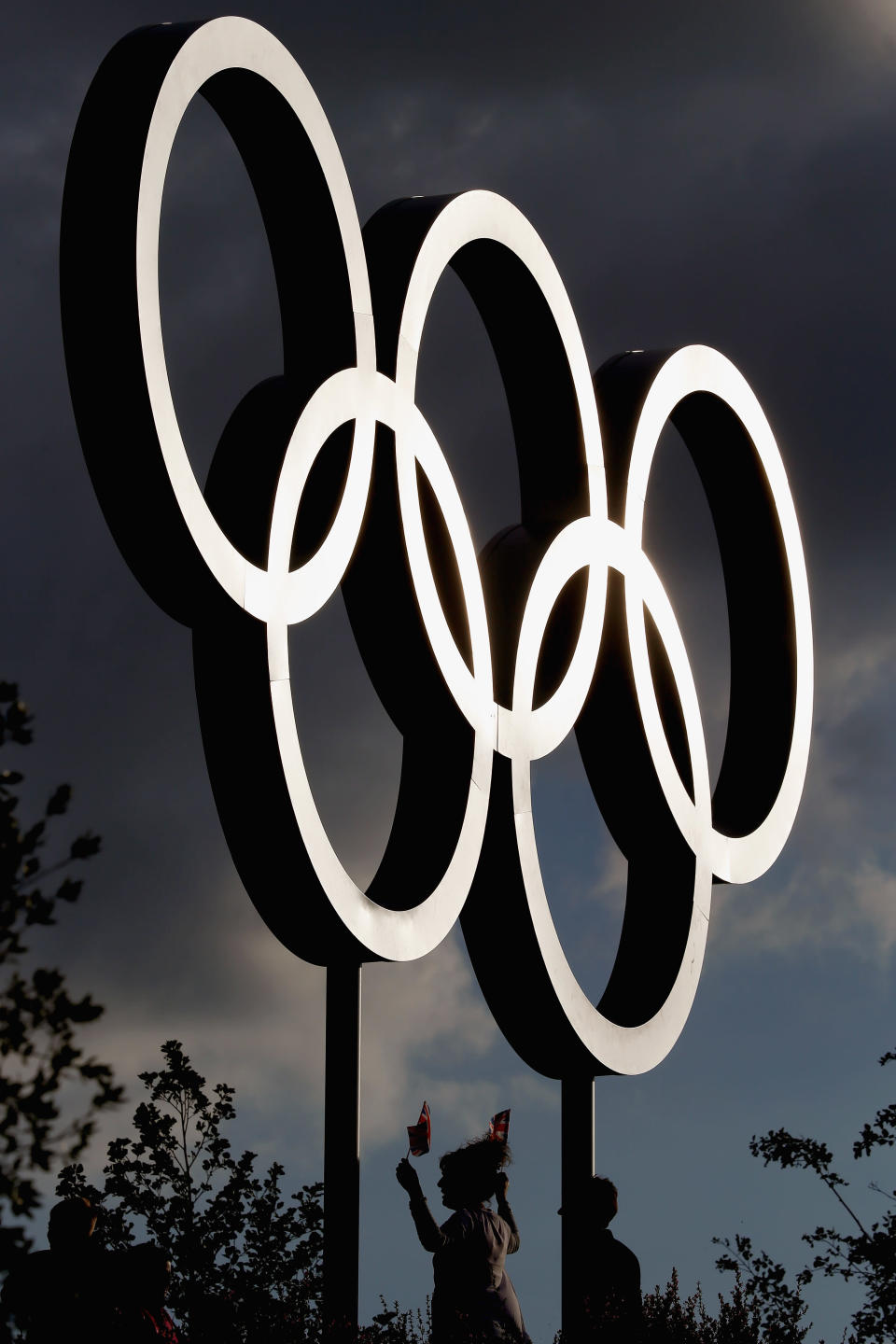 Members of the public have their pictures taken in front of the Olympic Rings in the Olympic Park on day one of the London 2012 Olympic Games on July 28, 2012 in London, England. (Photo by Jeff J Mitchell/Getty Images)