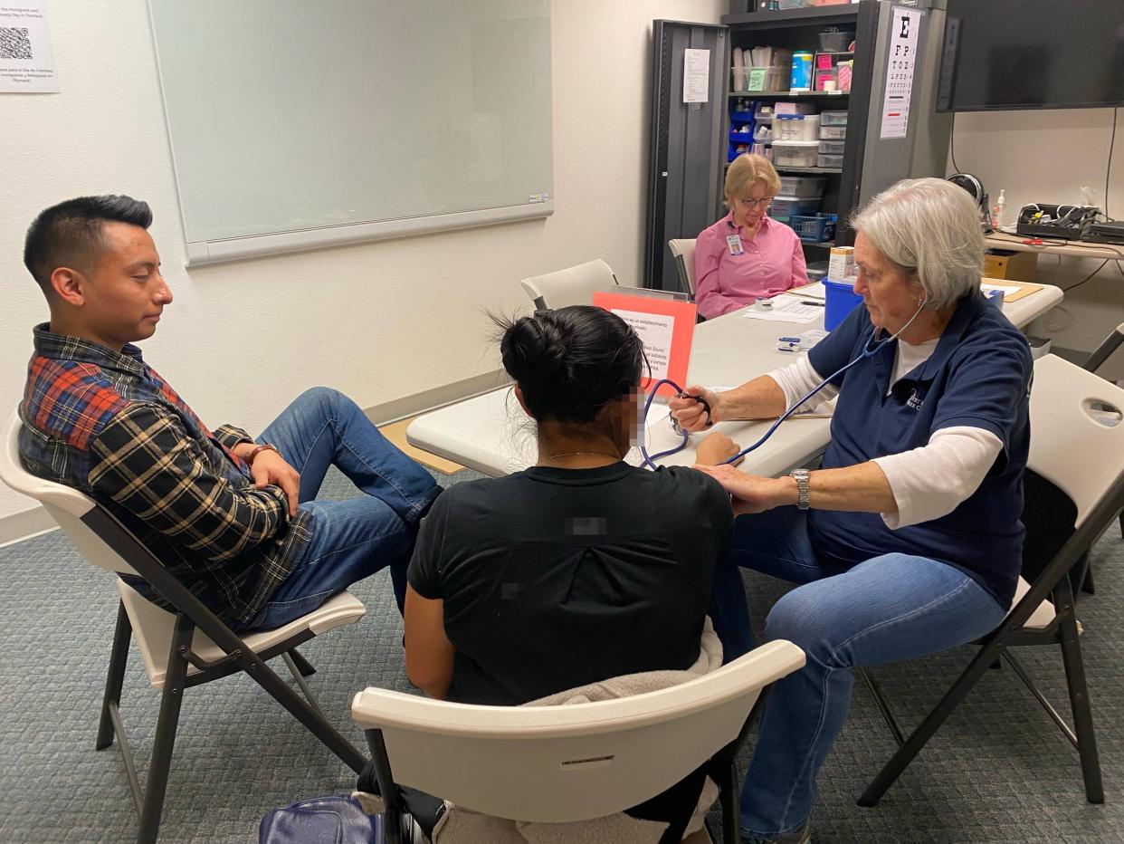 KIAC staff member Alex Tomas provides interpretation during medical clinic with West Sound Free Clinic volunteer.