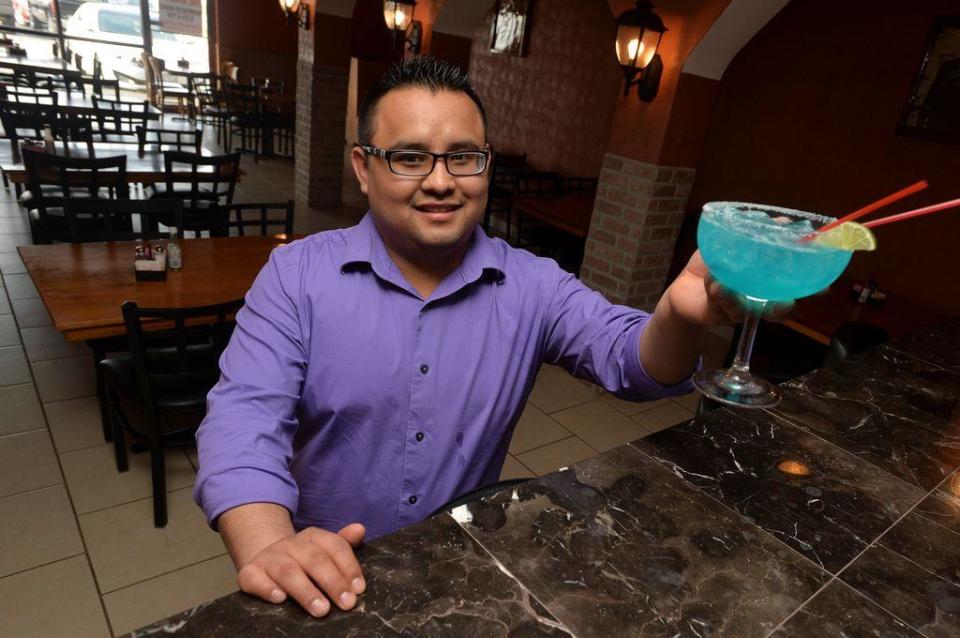 Mauricio Martinez of Blue Margaritas Mexican Bar and Grill displays one of the drinks the Peoria restaurant at 9010 North Allen Road in the Prairie Pointe Shopping Center is famous for.