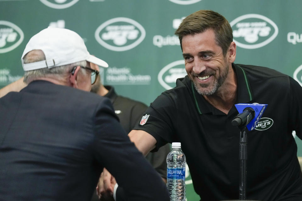 New York Jets' quarterback Aaron Rodgers shakes hands with Jets' owner Woody Johnson during an NFL football press conference at the Jets' training facility in Florham Park, N.J., Wednesday, April 26, 2023. (AP Photo/Seth Wenig)