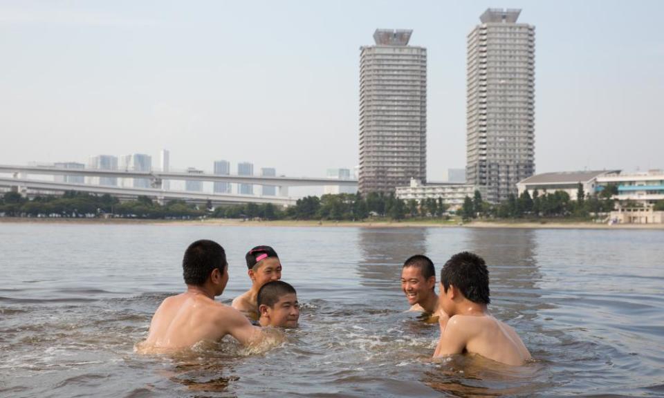 People cool off in Odaiba kaihin park during a deadly heatwave