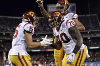 Southern California wide receiver Drake London, left, is congratulated by offensive tackle Jalen McKenzie (70) and wide receiver Michael Pittman Jr. (6) after scoring a touchdown during the first half of the Holiday Bowl NCAA college football game against Iowa, Friday, Dec. 27, 2019, in San Diego. (AP Photo/Orlando Ramirez)