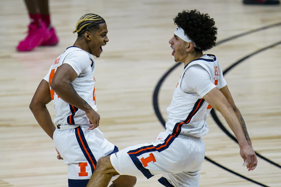 Illinois' Adam Miller, left, and Andre Curbelo celebrate during the second half of the team's NCAA college basketball game against Rutgers at the Big Ten Conference men's tournament in Indianapolis, Friday, March 12, 2021. (AP Photo/Michael Conroy)