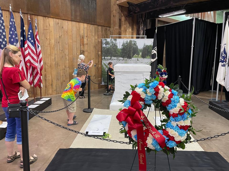 People look at the half-scale replica of the Tomb of the Unknown Soldier at the South Dakota Military Heritage Alliance in Sioux Falls on Saturday.