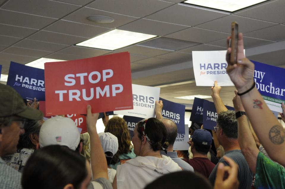 Signs being held by Vice President Kamala Harris' supporters at a St. Paul, Minnesota, campaign kickoff.