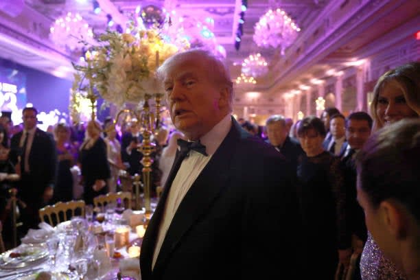 Former US president Donald Trump greets people as he arrives for a New Years event at his Mar-a-Lago home on 31 December 2022 in Palm Beach, Florida (Getty Images)