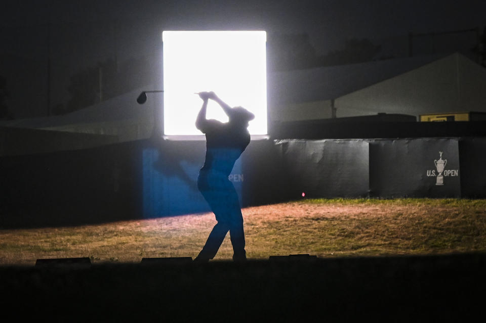 SAN DIEGO, CA - JUNE 17:  Bryson DeChambeau is silhouetted as he hits balls at night on the practice range after play following the first round of the 121st U.S. Open on the South Course at Torrey Pines Golf Course on June 17, 2021 in La Jolla, San Diego, California. (Photo by Keyur Khamar/PGA TOUR via Getty Images)