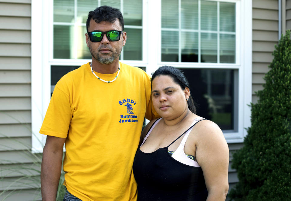 In this Aug. 2, 2019 photo, Ashlyn Gonzales, right, and her longtime partner Emanuel Rivera pose outside their condo in Portland, Conn. In the months after Hurricane Maria destroyed their home in Puerto Rico, the couple moved to Connecticut, where federal and state aid helped them avoid homelessness. But aid at both levels has just about dried up, leaving the pair and many like them wondering what they are going to do next. (AP Photo/Chris Ehrmann)