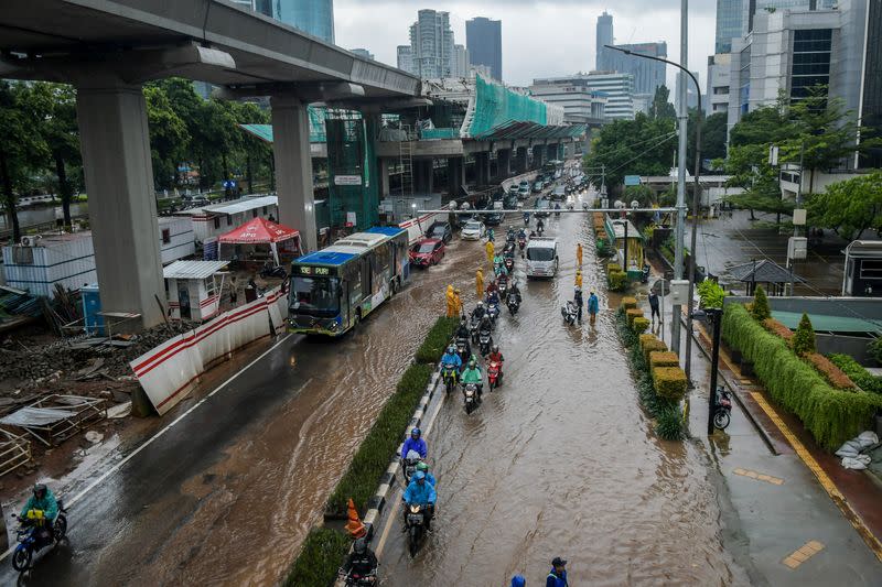 Transportation along a flooded street in Jakarta