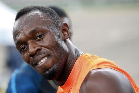 Jamaica's Usain Bolt smiles shortly after crossing the finish line first, in his first race of the season during the Gibson Relays in Kingston February 28, 2015. REUTERS/Gilbert Bellamy