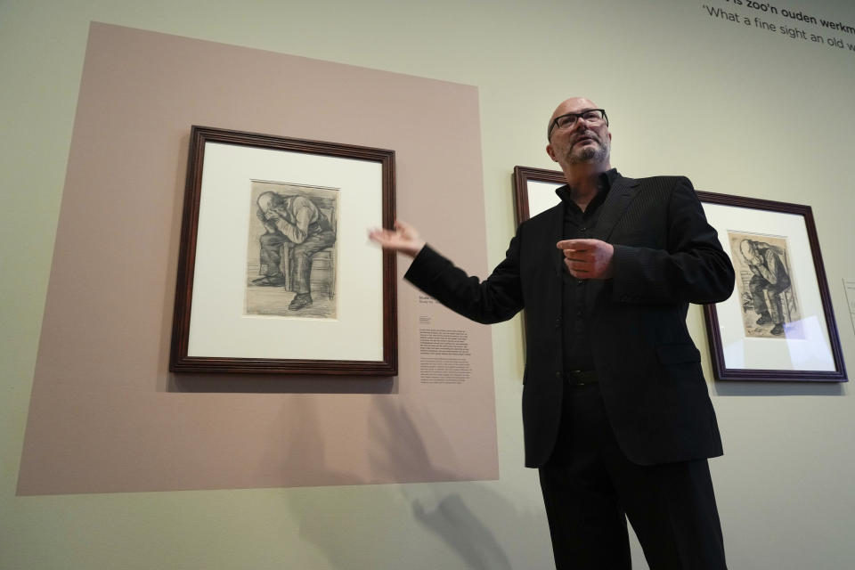 Senior researcher Teio Meedendorp gestures during the presentation of Study for "Worn Out", left, a drawing by Dutch master Vincent van Gogh, dated Nov. 1882, going on public display for the first time at the Van Gogh Museum in Amsterdam, Netherlands, Thursday, Sept. 16, 2021. (AP Photo/Peter Dejong)