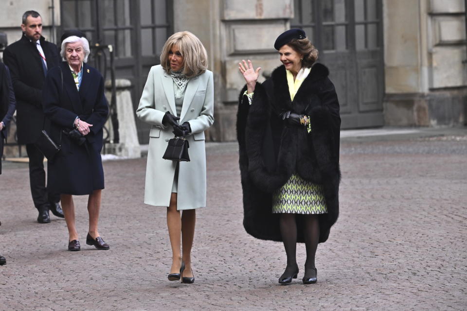 Sweden's Queen Silvia, right, and Brigitte Macron, wife of French President Emmanuel Macron, during a welcome ceremony at the Inner Courtyard of the Royal Palace in Stockholm, Sweden, Tuesday Jan. 30, 2024. France’s President Emmanuel Macron started a two-day state visit in Stockholm during which he will meet Swedish prime minister, Ulf Kristersson, and the country’s monarch, King Carl XVI Gustaf. (Claudio Bresciani/TT via AP)