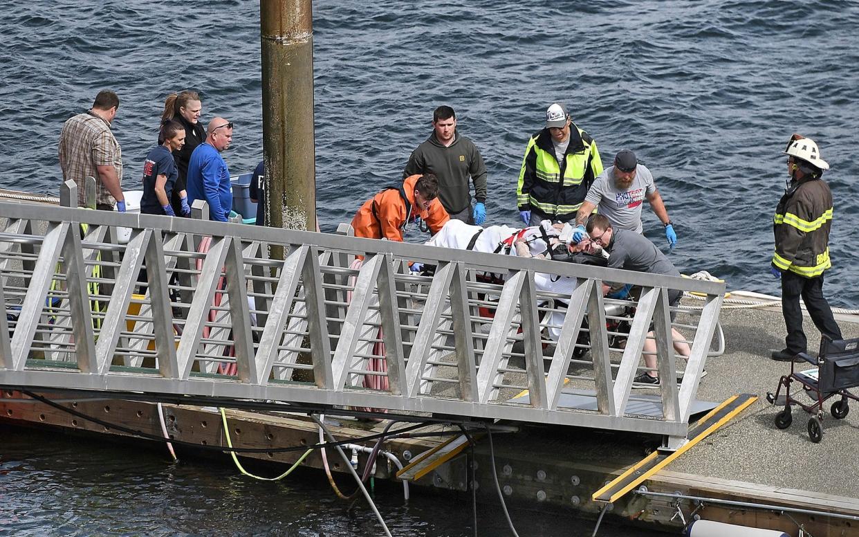 Emergency response crews transport an injured passenger to an ambulance at the George Inlet Lodge docks - Ketchikan Daily News