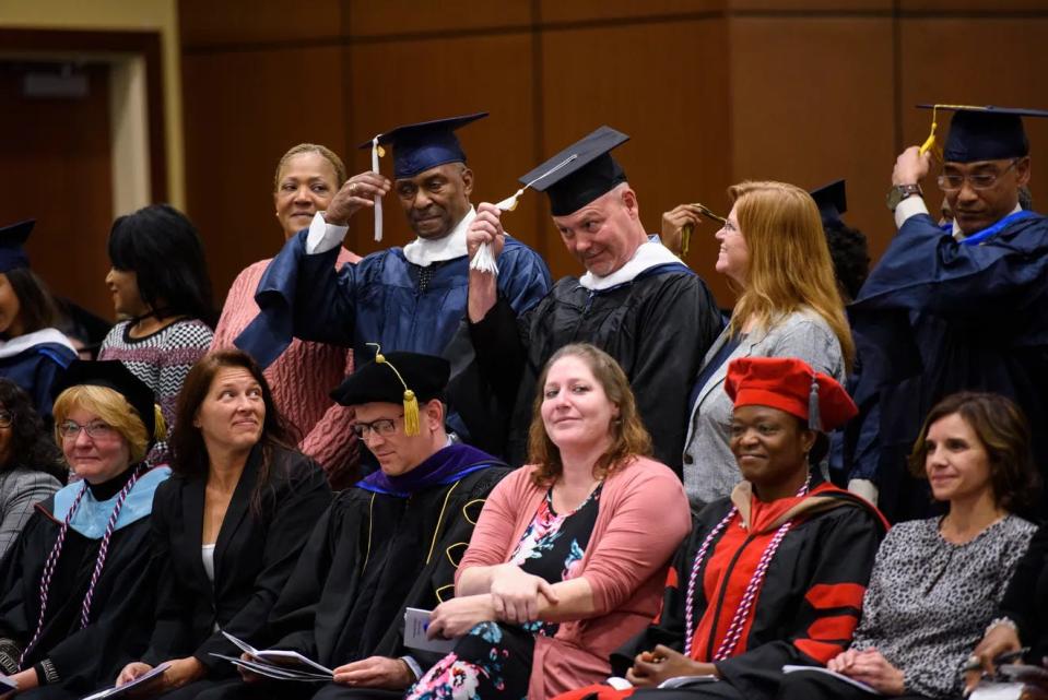 Graduates turn their tassels during a ceremony at Fort Liberty, then Fort Bragg, in this file photo from Nov. 14, 2019. More than 100 veterans, soldiers and military spouses who earned degrees online from colleges and universities during the previous year participated in one big graduation ceremony at the installation.