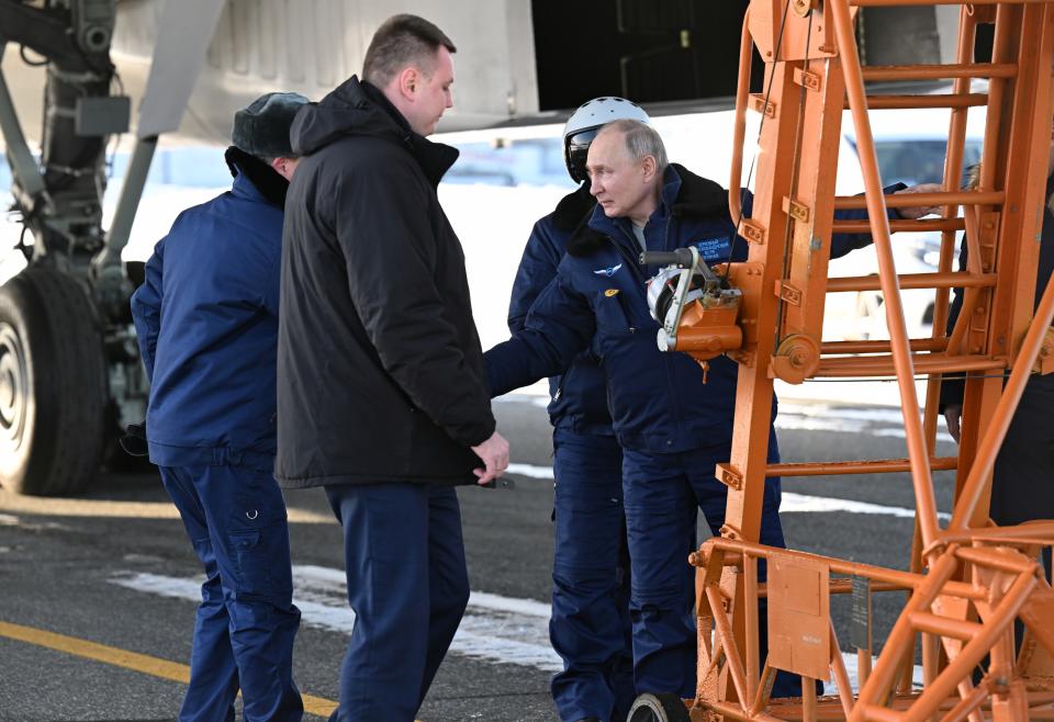 Russian President Vladimir Putin, center, boards a Tu-160M strategic bomber in Kazan, Russia, Thursday, Feb. 22, 2024. (Dmitry Azarov, Sputnik, Kremlin Pool Photo via AP)