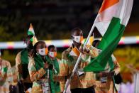 <p>Ivory Coast's flag bearers Marie-Josee Ta Lou (L) and bearer Cheick Sallah Cisse lead their delegation as they parade during the opening ceremony of the Tokyo 2020 Olympic Games, at the Olympic Stadium, in Tokyo, on July 23, 2021. (Photo by Odd ANDERSEN / AFP) (Photo by ODD ANDERSEN/AFP via Getty Images)</p> 