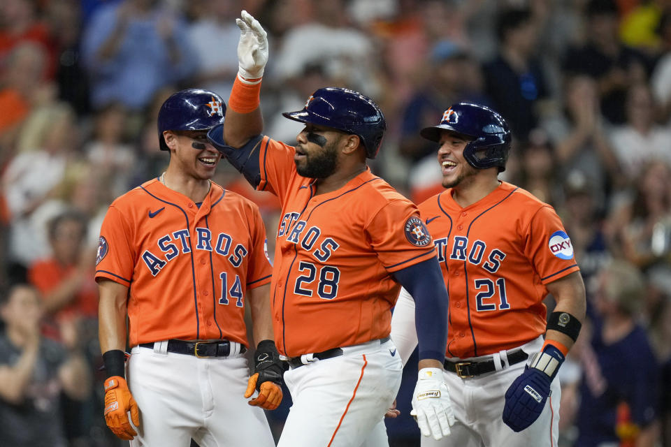 Houston Astros' Jon Singleton (28) celebrates his three-run home run against the Los Angeles Angels with Mauricio Dubon (14) and Yainer Diaz during the second inning of a baseball game Friday, Aug. 11, 2023, in Houston. (AP Photo/Eric Christian Smith)