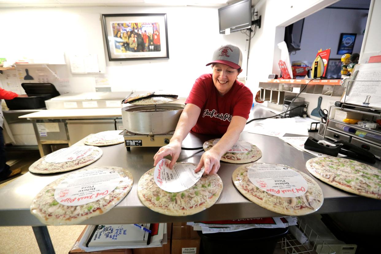 Chef Fresh Pizza co-owner Carol Doran prepares deluxe pizzas for wholesale customers such as bars, hotels and campgrounds.