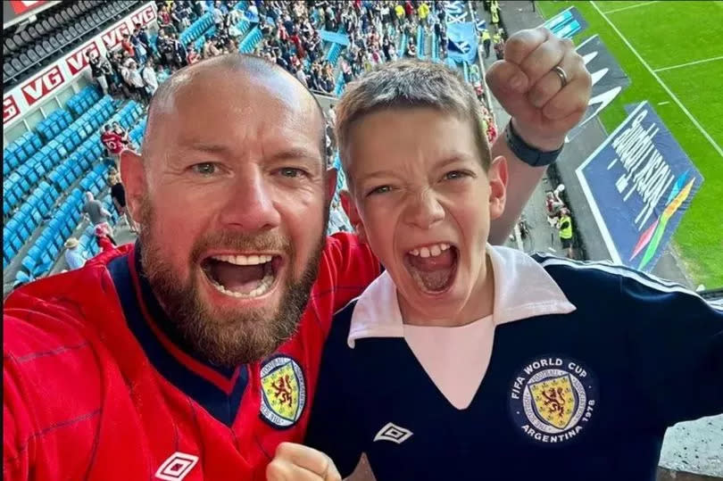 The father and son celebrating Scotland's dramatic win in Norway in 2023.