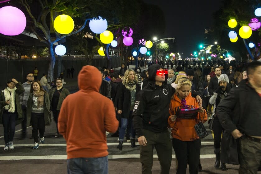 LOS ANGELES, CA - DECEMBER 31, 2015: Crowds of people arrive at 1st Street and Broadway for the New Year's Eve celebration at Grand Park on December 31, 2015 in Los Angeles, California.(Gina Ferazzi / Los Angeles Times)